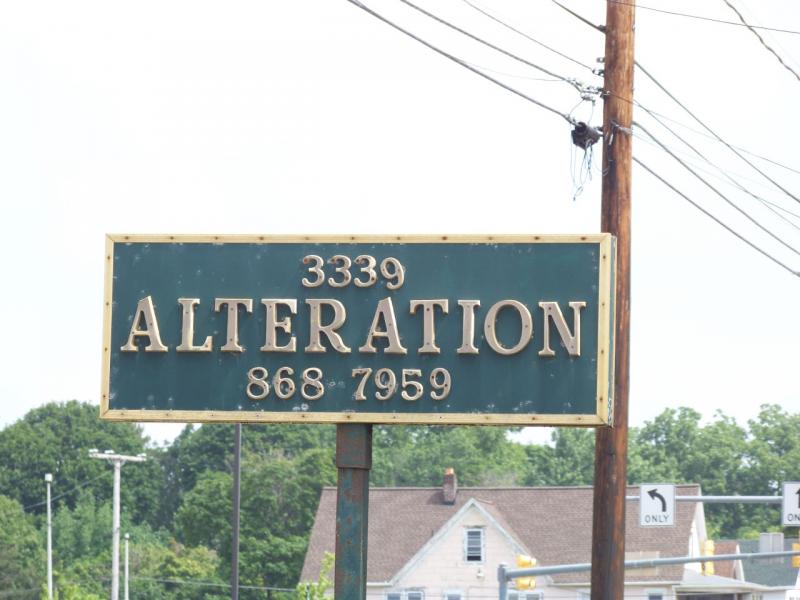 Birch International Seamstress alteration sign on Peach Street