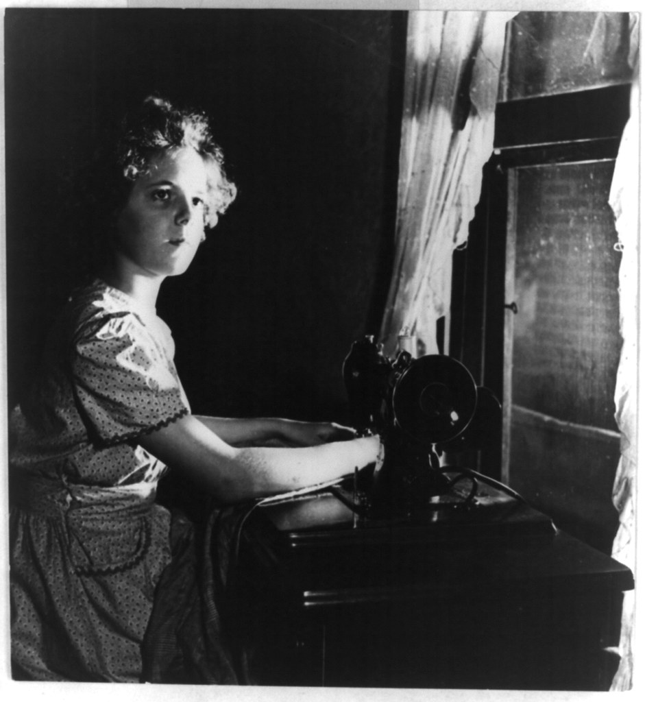 Portrait of a person seated at a sewing machine